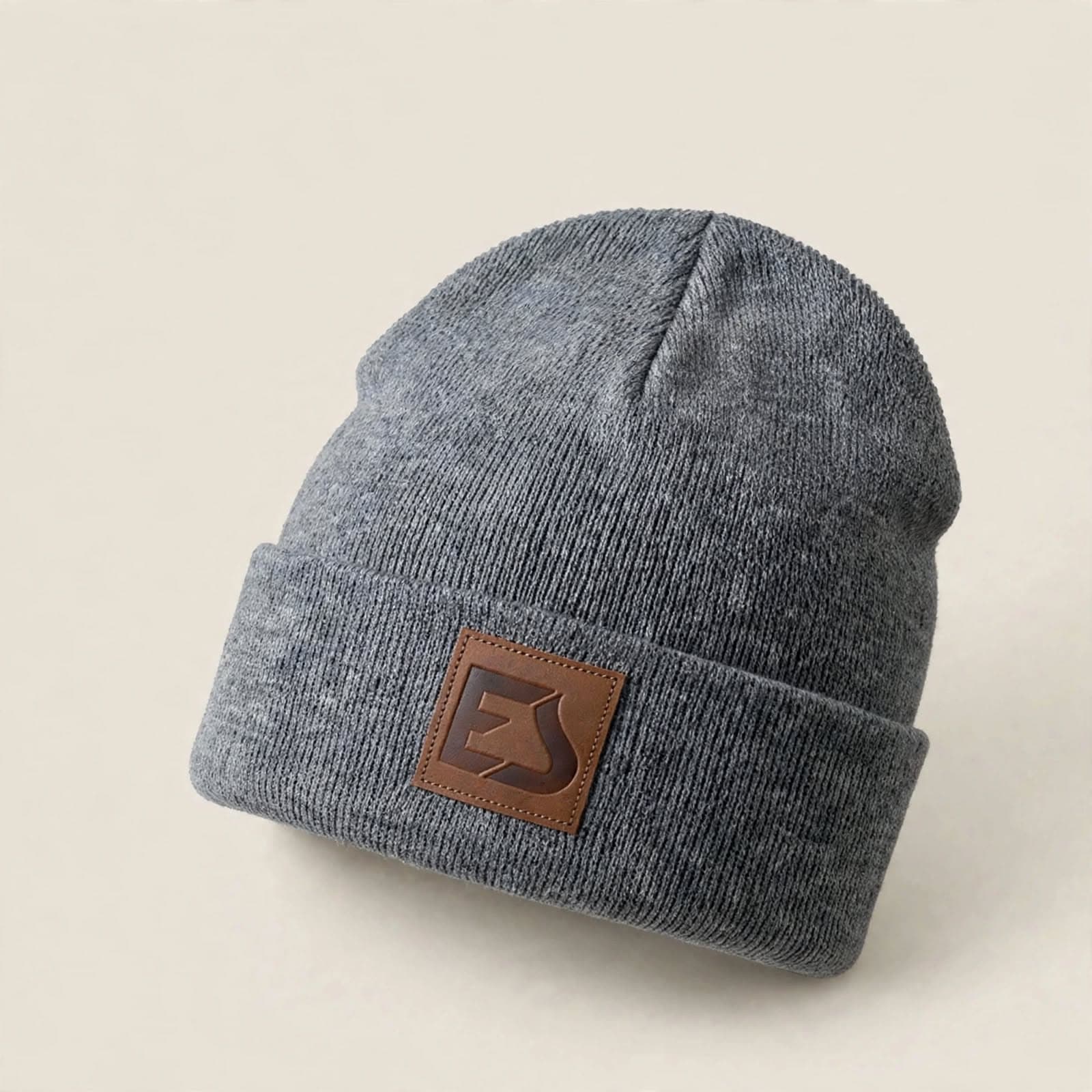 Grey cuffed beanie with a leather patch label