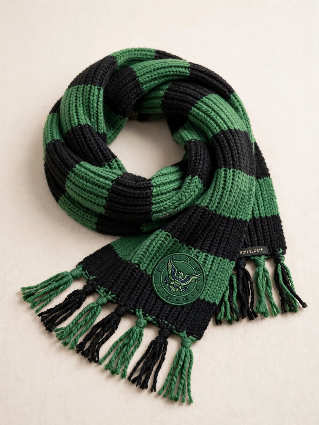 Green and black striped fan scarf with an embroidered crest